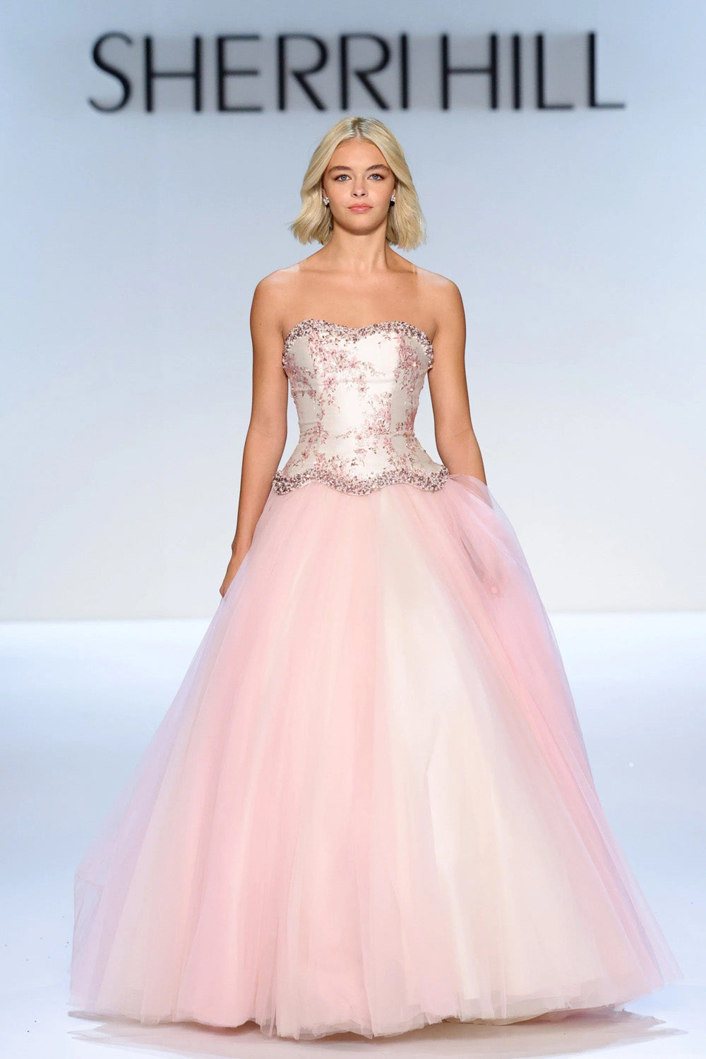 Sherri Hill 58808 pink gold print full length ballgown with scalloped beaded waist and layered blush tulle skirt on runway