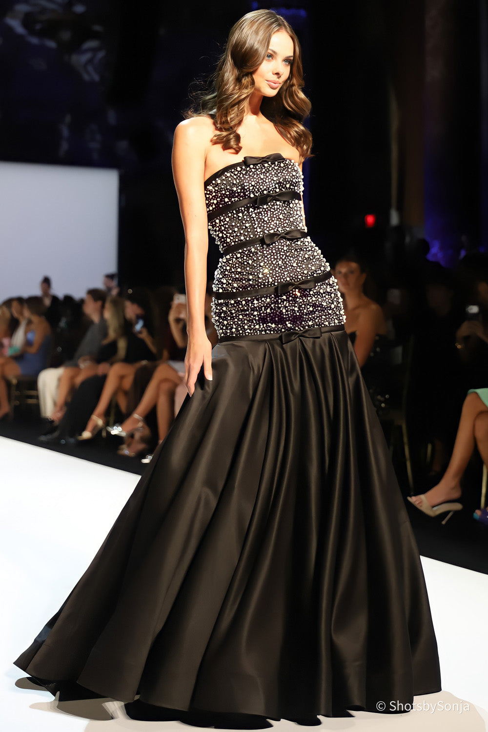 Sherri Hill 58929 black silver gown side view showing beaded bodice satin bows and sweeping full length skirt