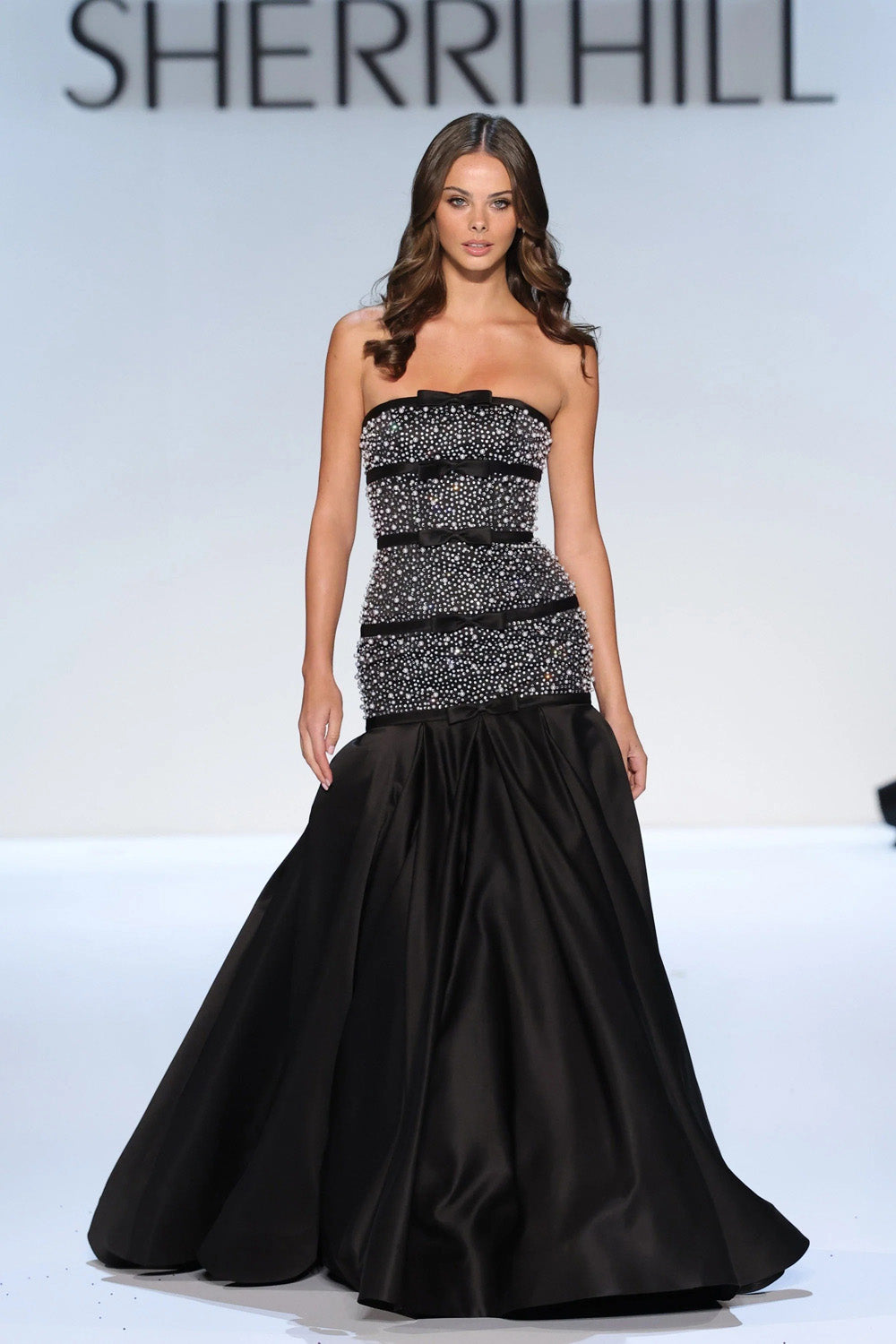 Sherri Hill 58929 black silver full length view of beaded bodice with dropped waist bow and pleated satin ball skirt
