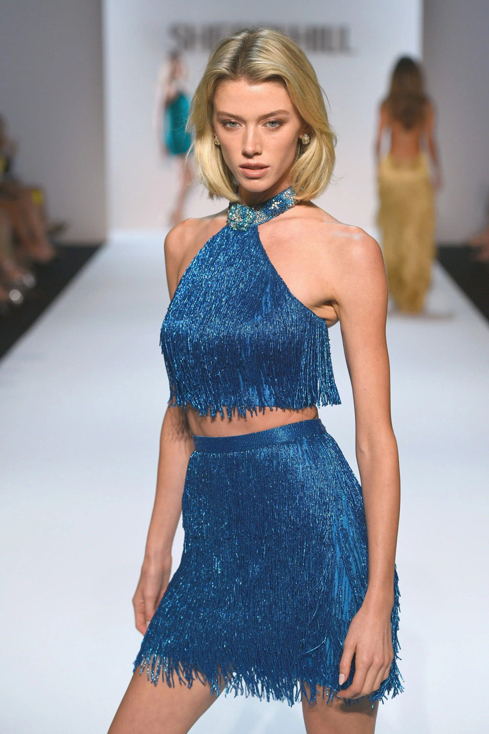 Sherri Hill 67346 aqua silver AB metallic fringe two piece halter set three quarter view showing neckline beading and skirt movement