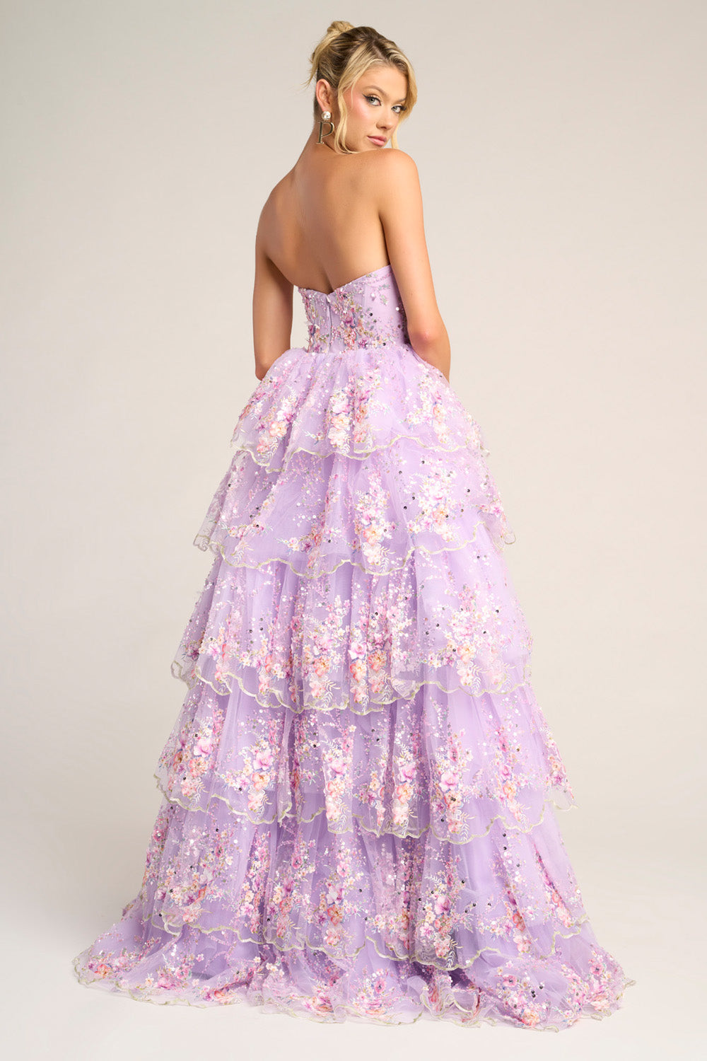 Portia and Scarlett PS26051 Lilac tiered prom dress with floral embellishments and a strapless back view.