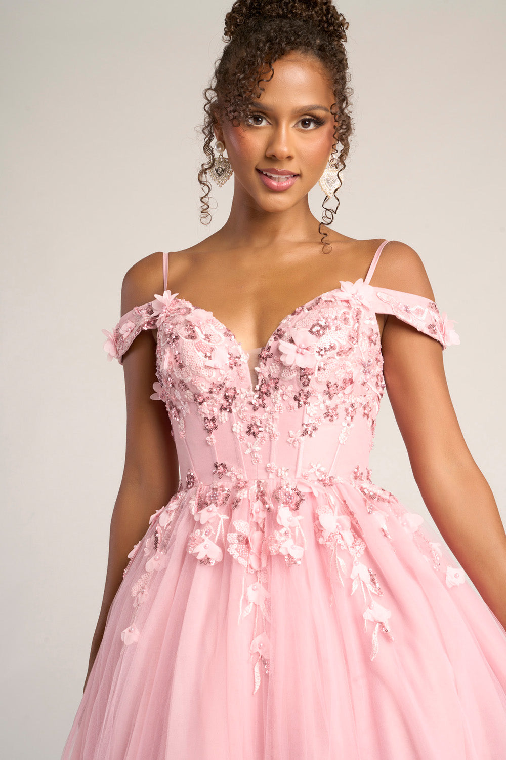 Portia and Scarlett PS26055 Pink prom dress with floral embellishments and a fitted bodice, front view.