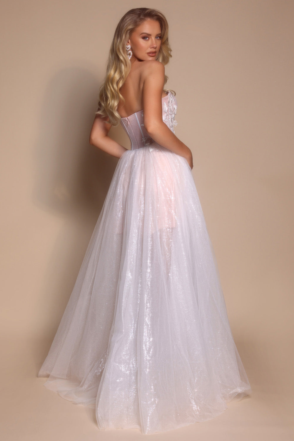 Portia and Scarlett PS26078 Ivory formal gown with a fitted bodice and flowing skirt, featuring a lace-up back.