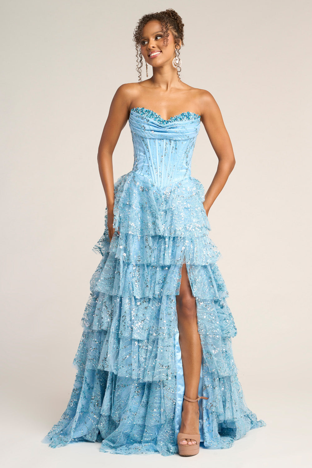 Portia and Scarlett PS26099 Blue tiered prom dress with a high slit and sparkling sequins, front view.