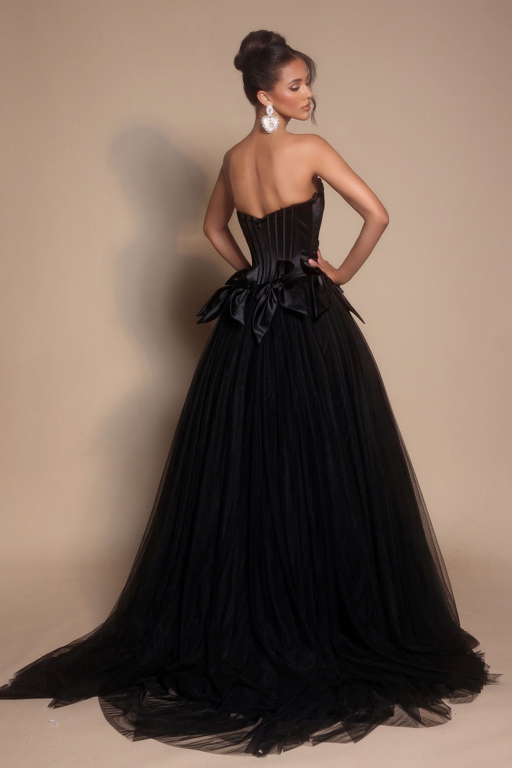 Portia and Scarlett PS26102 Black ballgown prom dress with a corset back and dramatic bow detail.