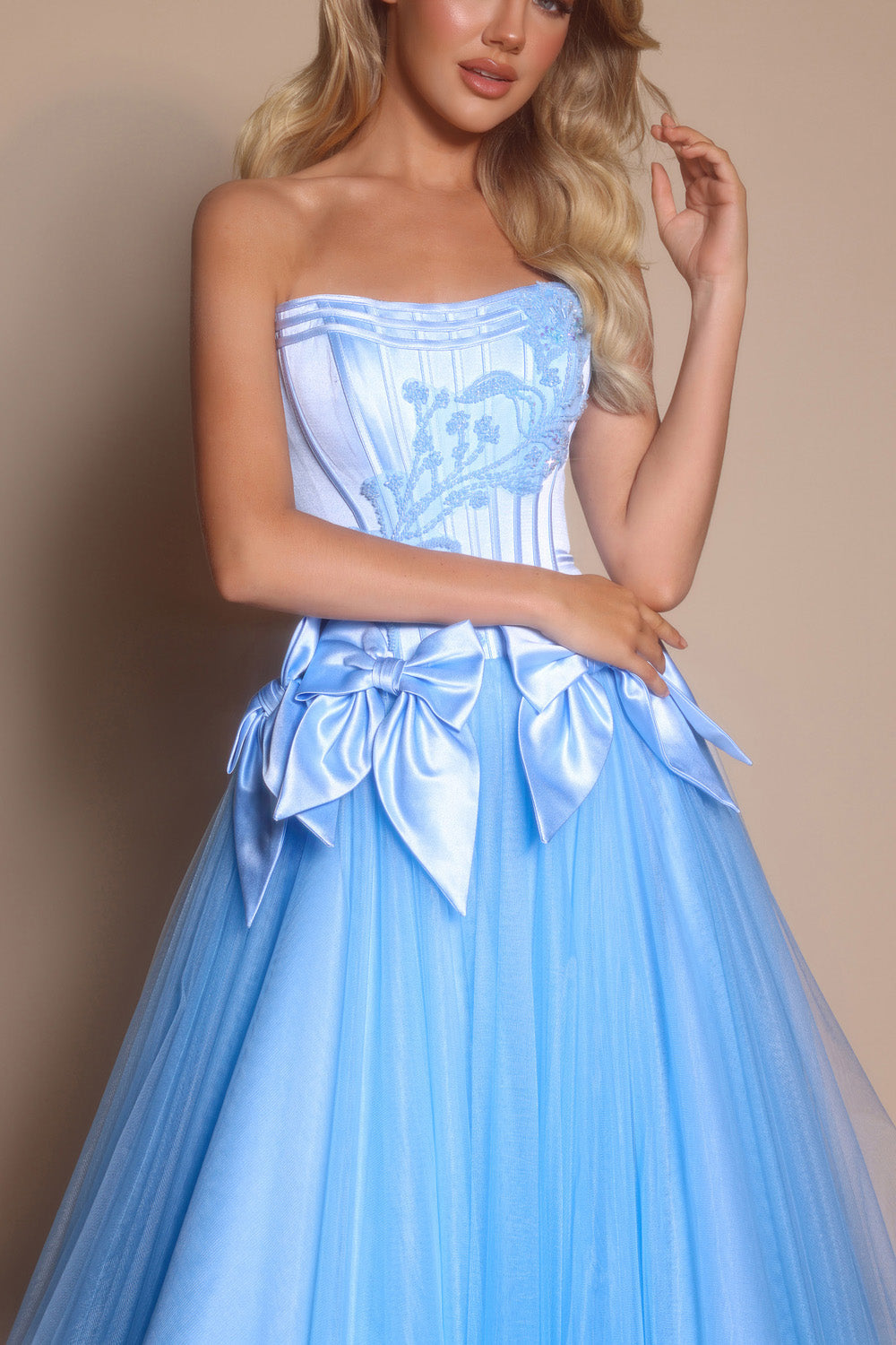 Portia and Scarlett PS26102 Light blue A-line prom dress with intricate beading and bow details.
