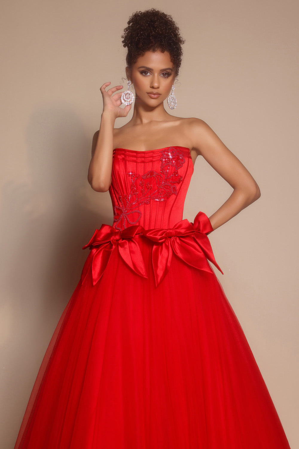 Portia and Scarlett PS26102 Red strapless prom dress with a fitted bodice, beaded detailing, and a full skirt.