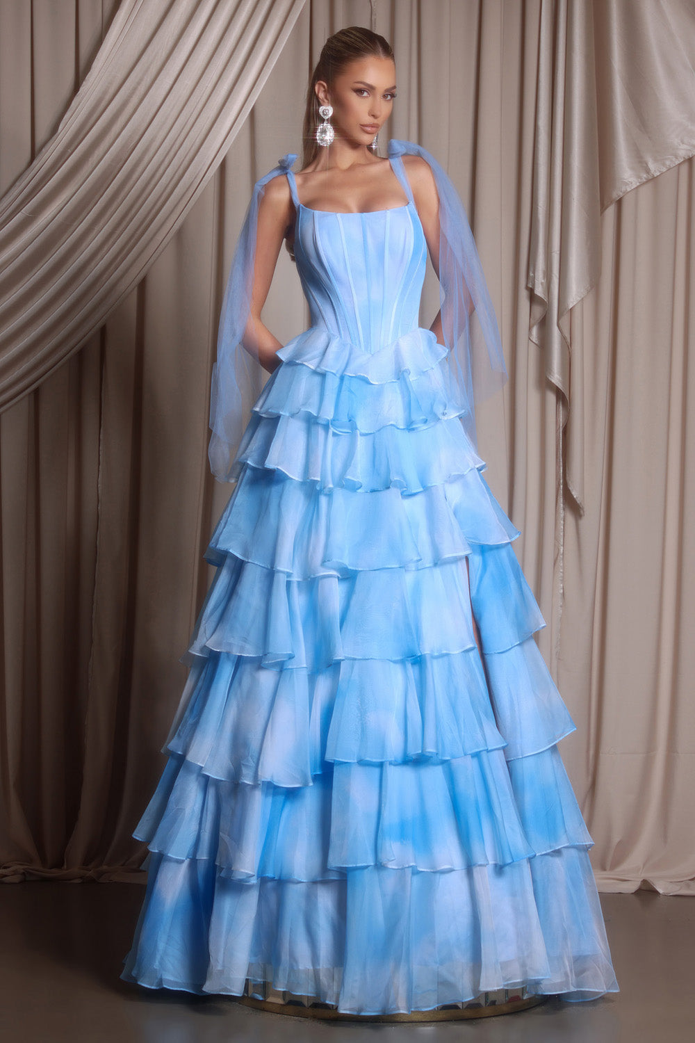 Portia and Scarlett PS26143 Blue tiered prom dress with a fitted bodice and flowing layers.