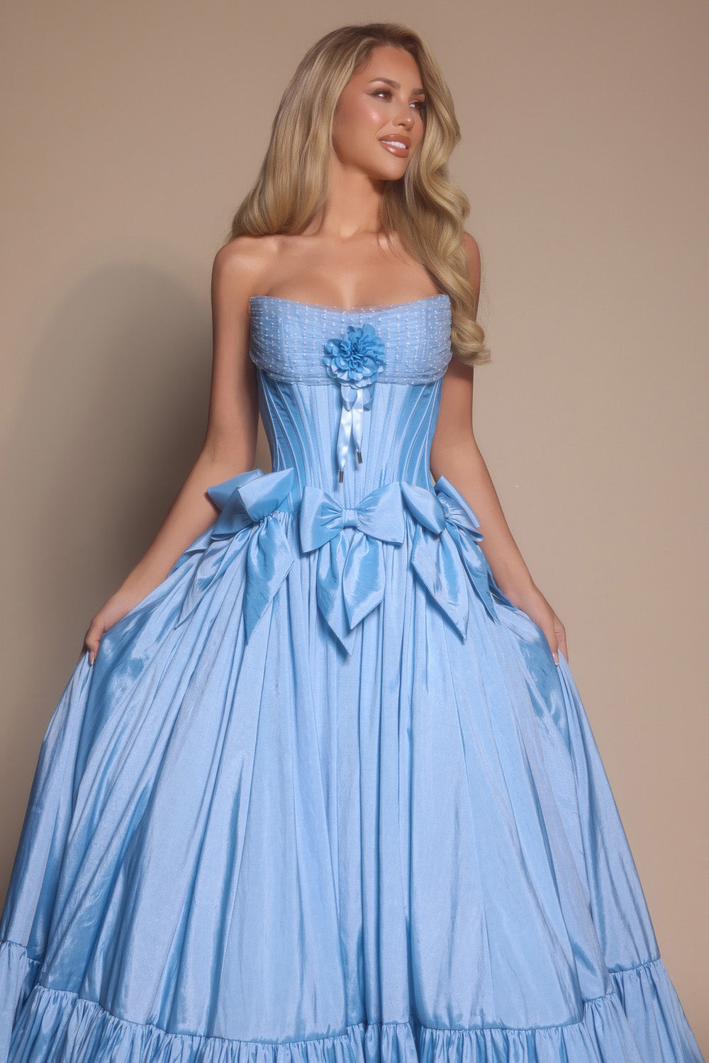 Portia and Scarlett PS26148 Light blue ballgown prom dress with a floral accent and bow details.