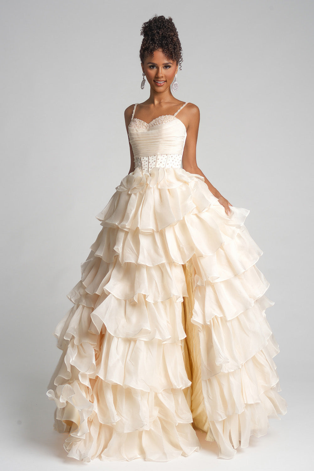 Portia and Scarlett PS26155 Cream prom dress with ruffled layers and a fitted bodice, front view.