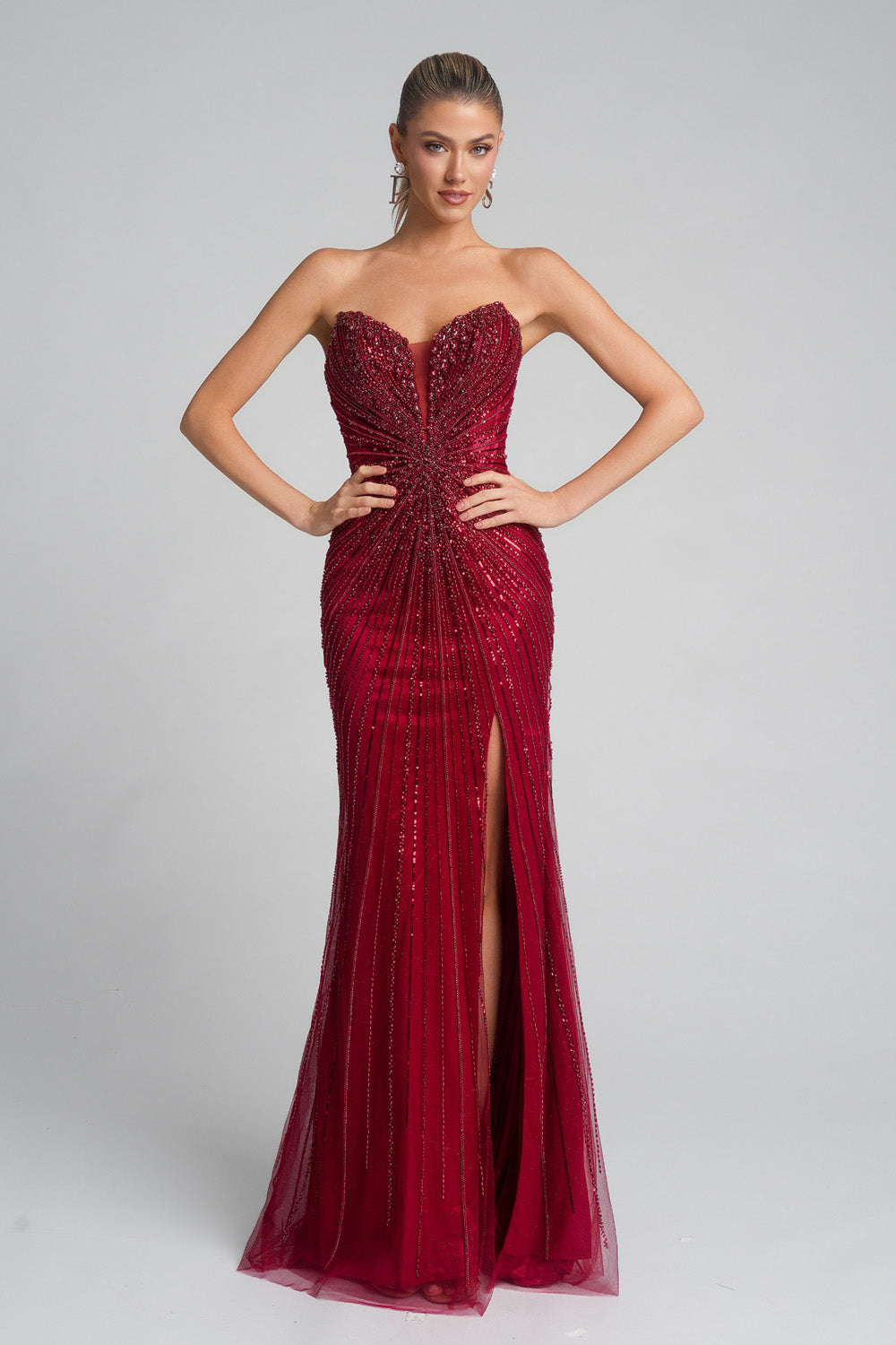 Portia and Scarlett PS26237 Red mermaid prom dress with beading and a thigh-high slit, front view.