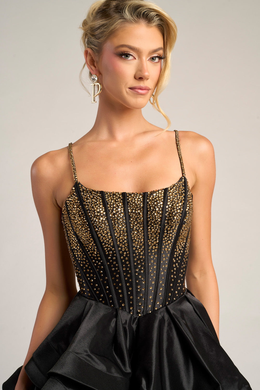 Portia and Scarlett PS26253 Black and gold prom dress with beaded bodice and flared skirt, front view.
