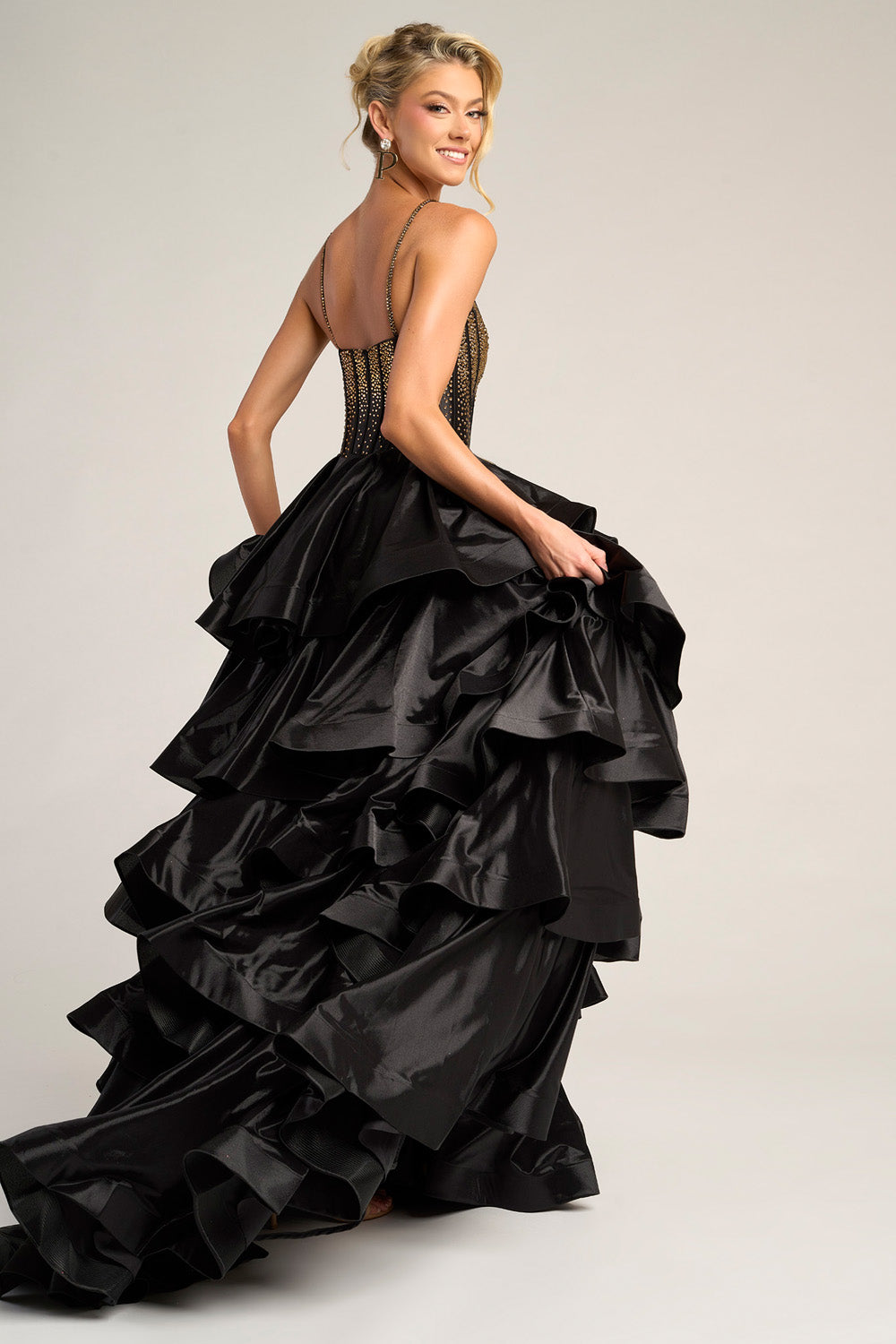 Portia and Scarlett PS26253 Black mermaid prom dress with ruffled skirt and intricate beading, back view.