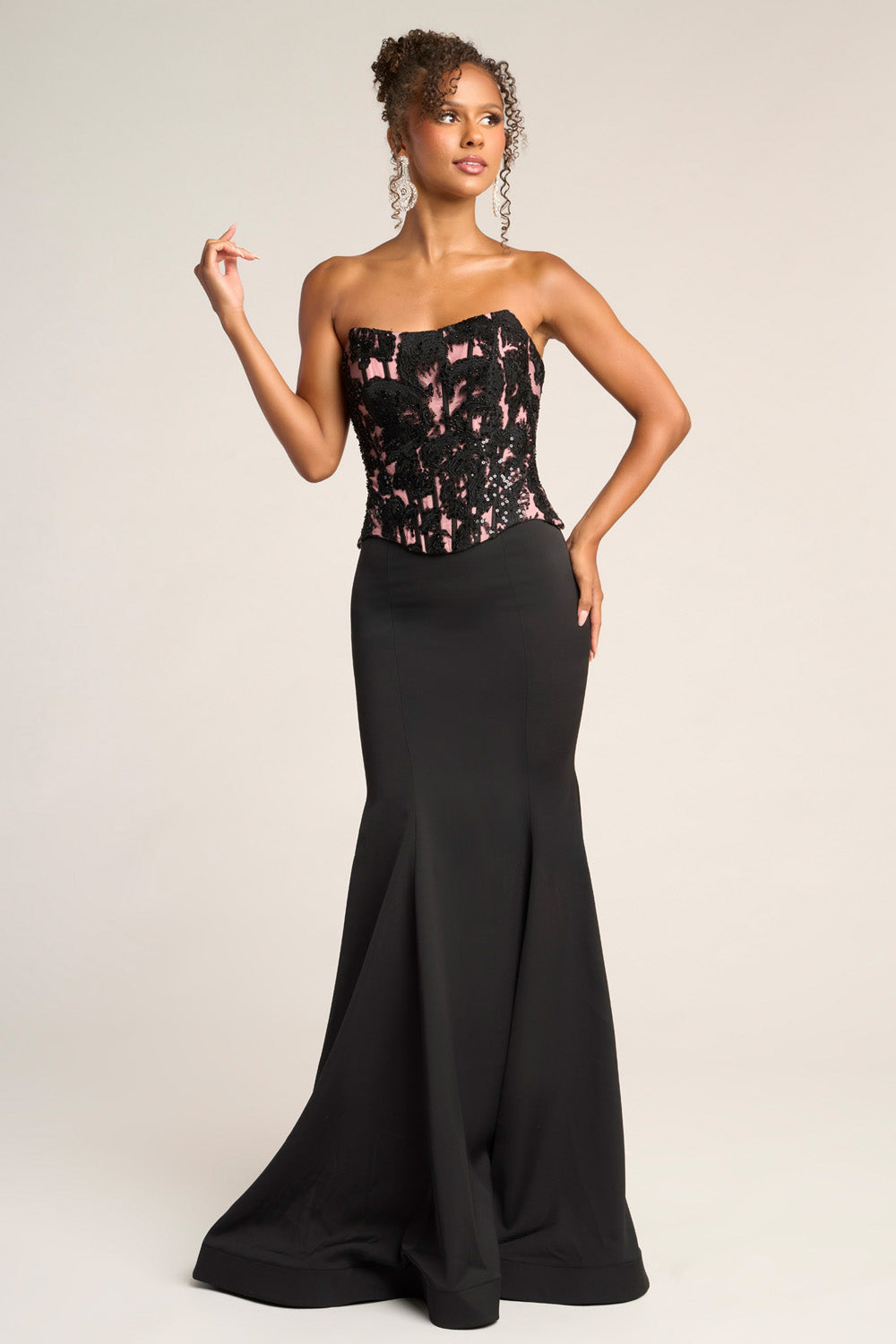 Portia and Scarlett PS26301e Black and nude mermaid prom dress with intricate lace detailing and a strapless design.