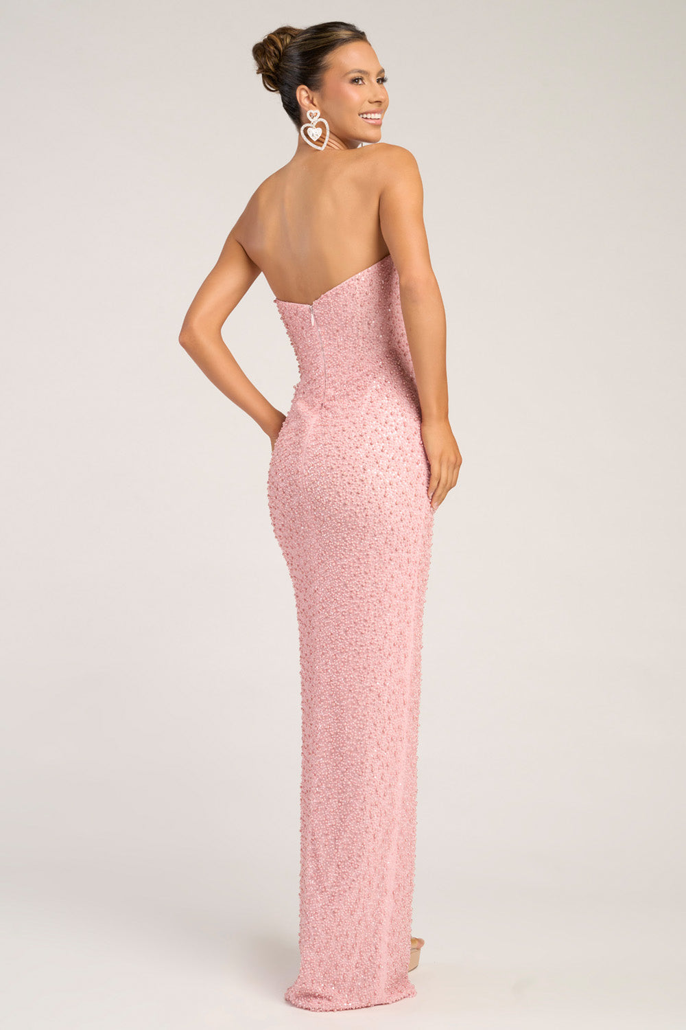 Portia and Scarlett PS26309e Pink fitted prom dress with sequins and a back zipper, side view.
