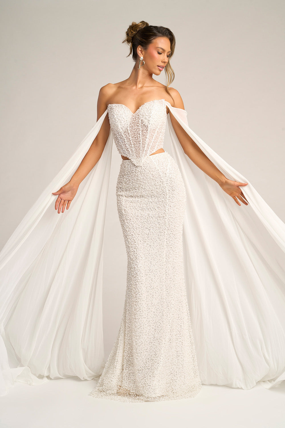 Portia and Scarlett PS26326e Ivory mermaid prom dress with beading and dramatic cape sleeves, front view.