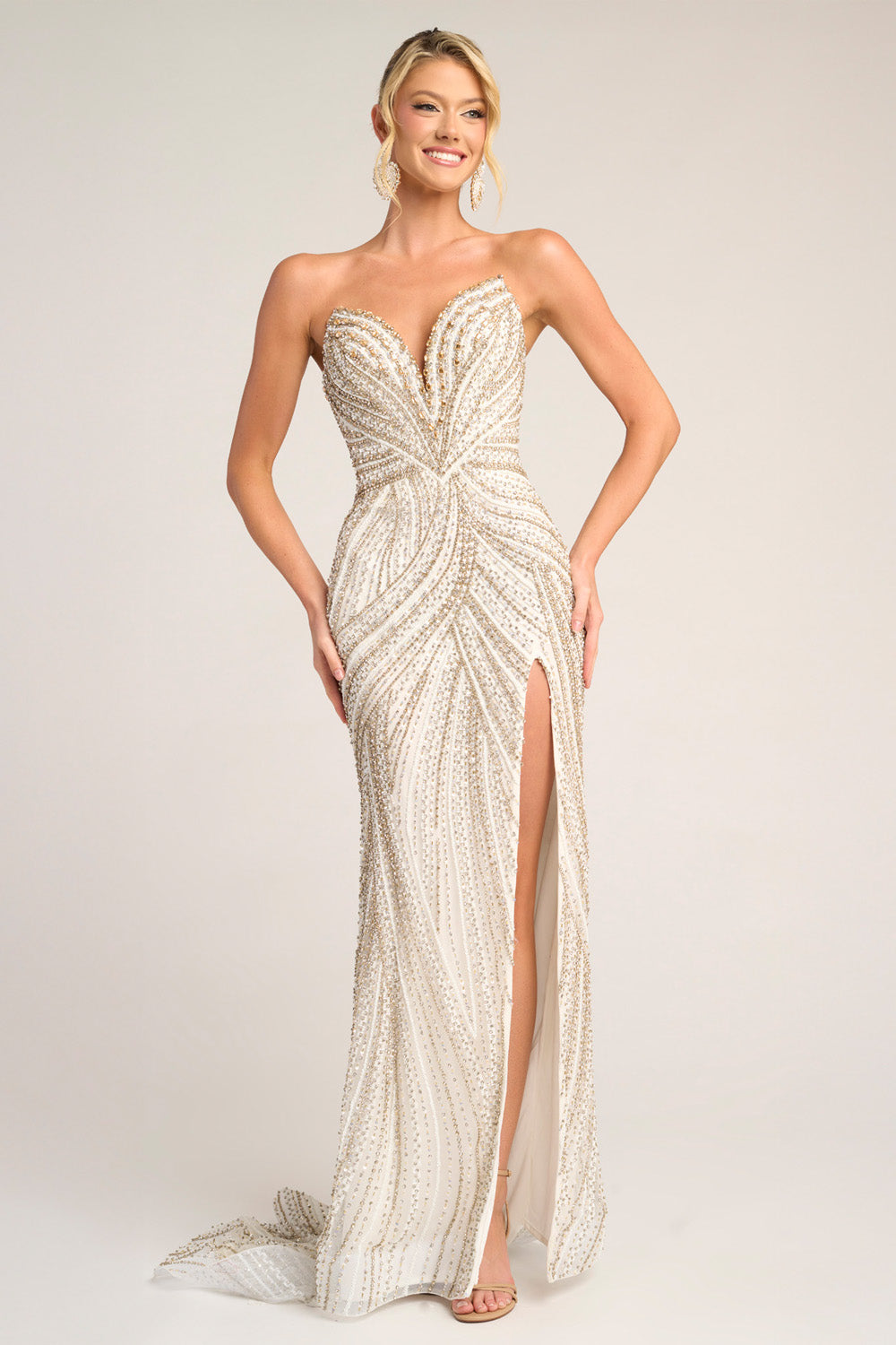 Portia and Scarlett PS26407c Ivory gold mermaid prom dress with beading and a thigh-high slit, front view.