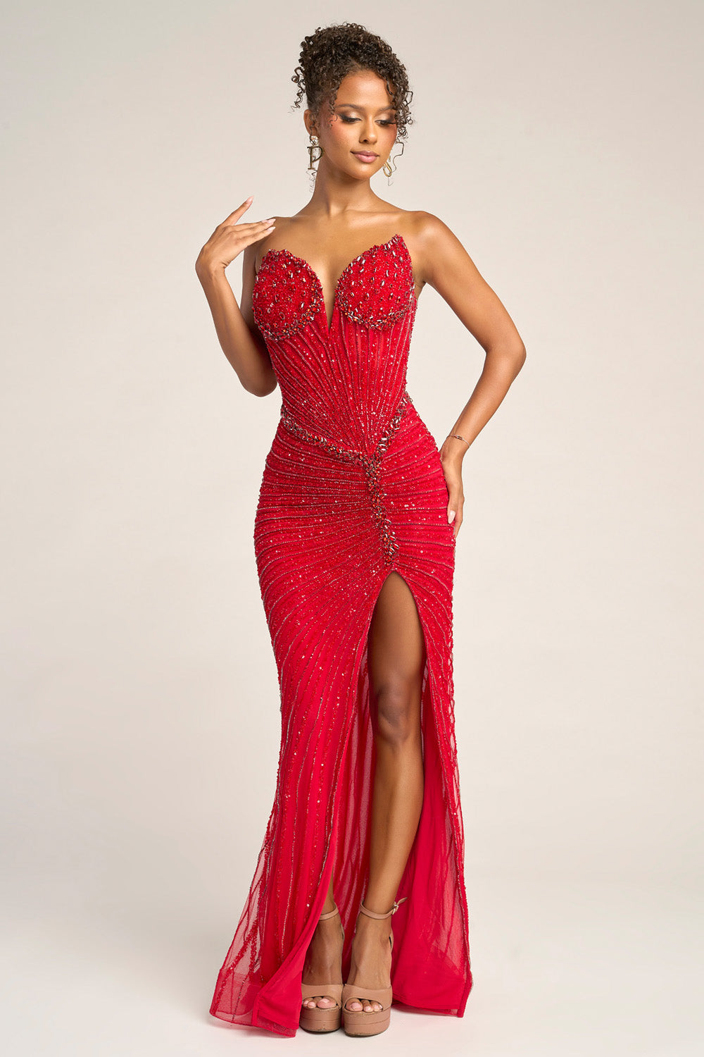 Portia and Scarlett PS26416c Red mermaid prom dress with beading and a thigh-high slit, front view.