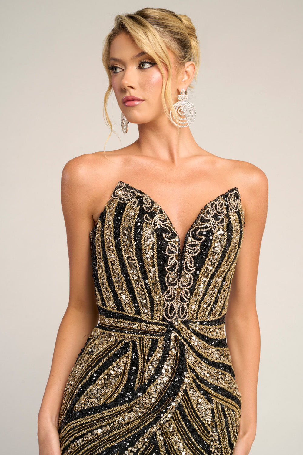 Portia and Scarlett PS26418c Black and gold sequined mermaid prom dress with a plunging neckline, front view.