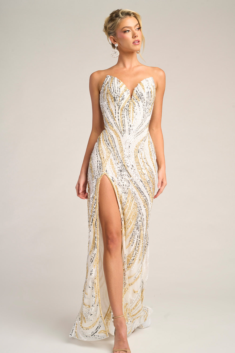 Portia and Scarlett PS26419c Ivory gold prom dress with a fitted silhouette and high slit, featuring sequins.