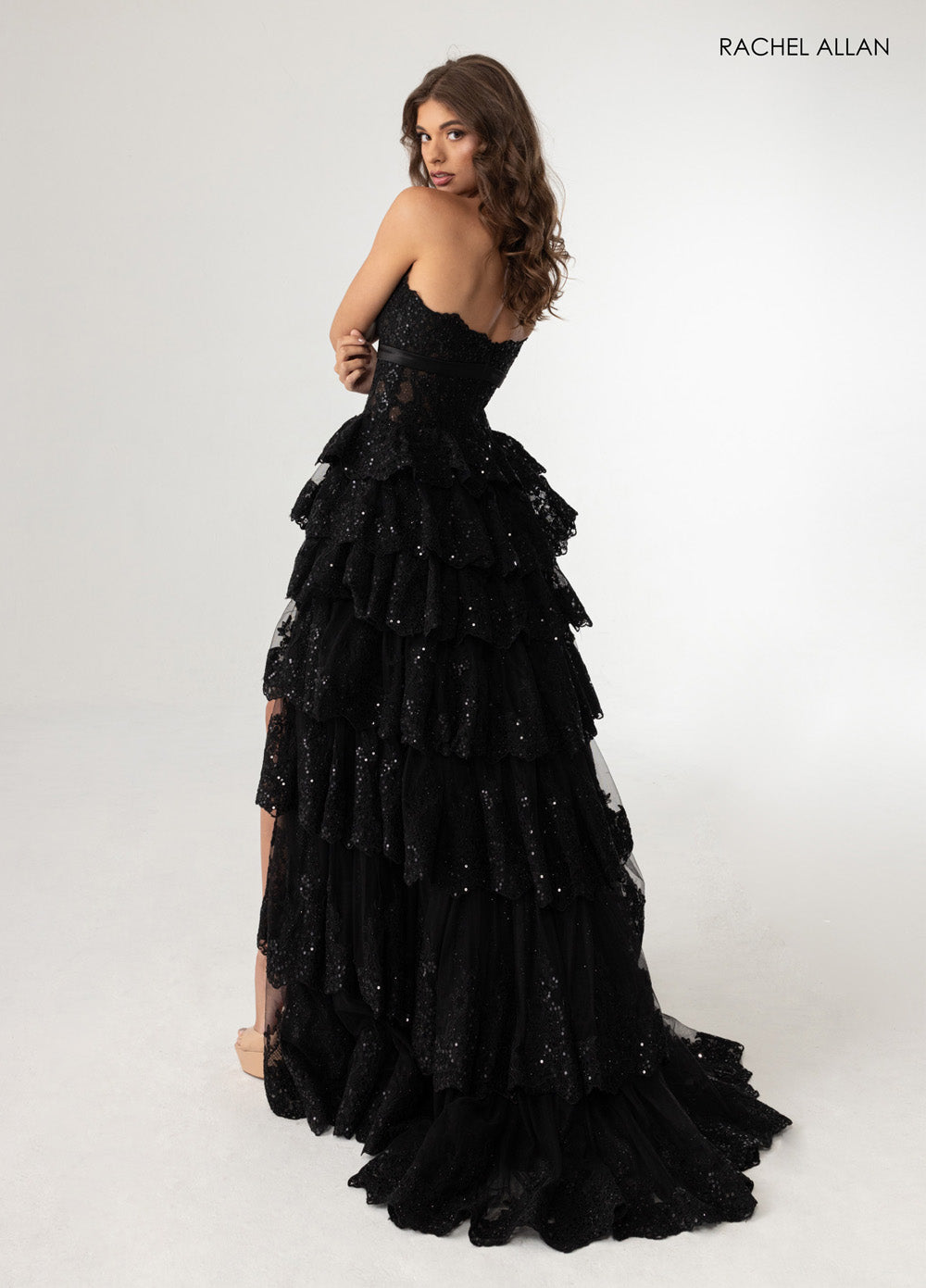 Rachel Allan 70944 Black tiered prom dress with sparkling sequins and a dramatic back view.