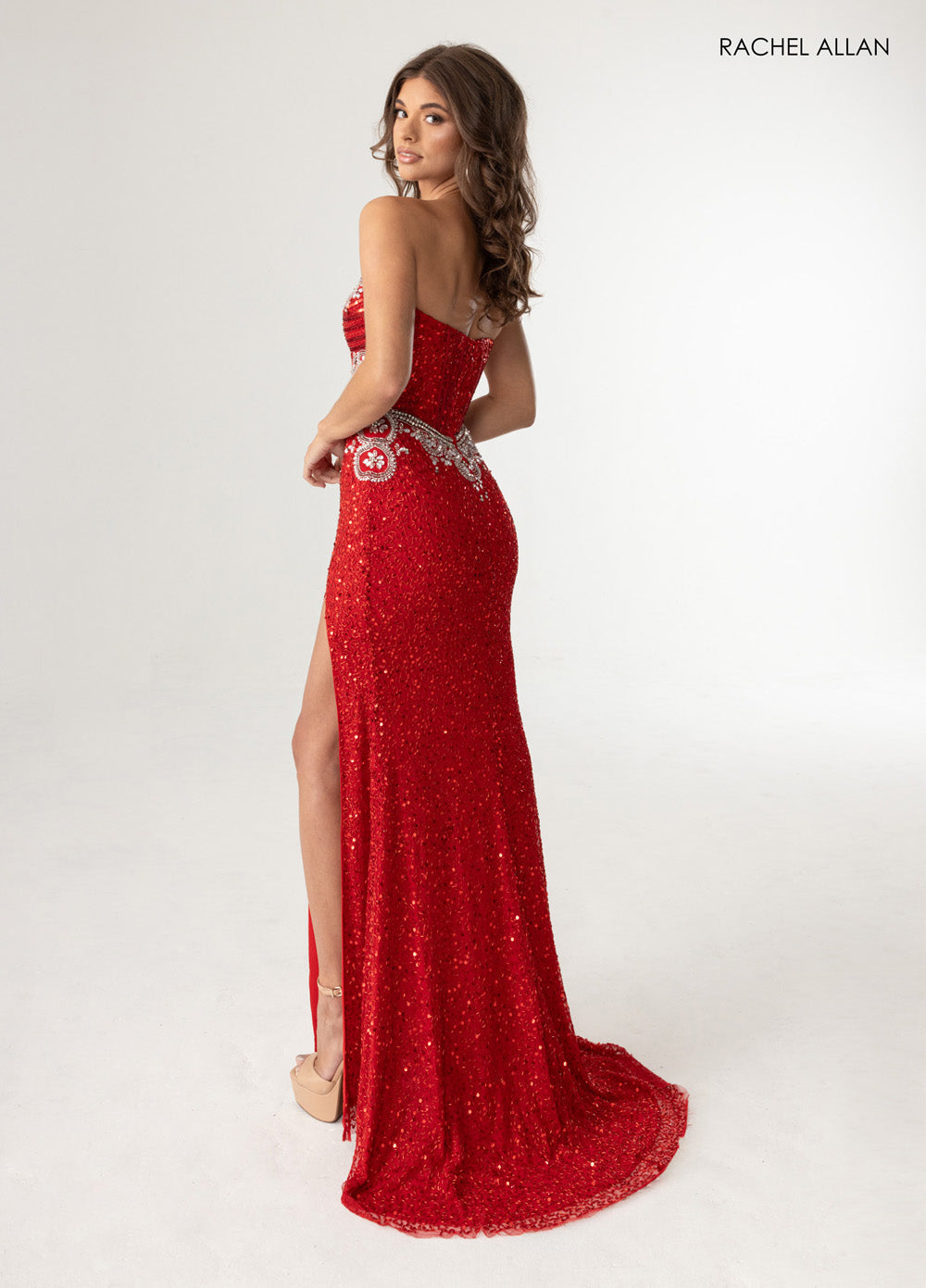 Rachel Allan 70952 Red fitted prom dress with beading and a thigh-high slit, back view.