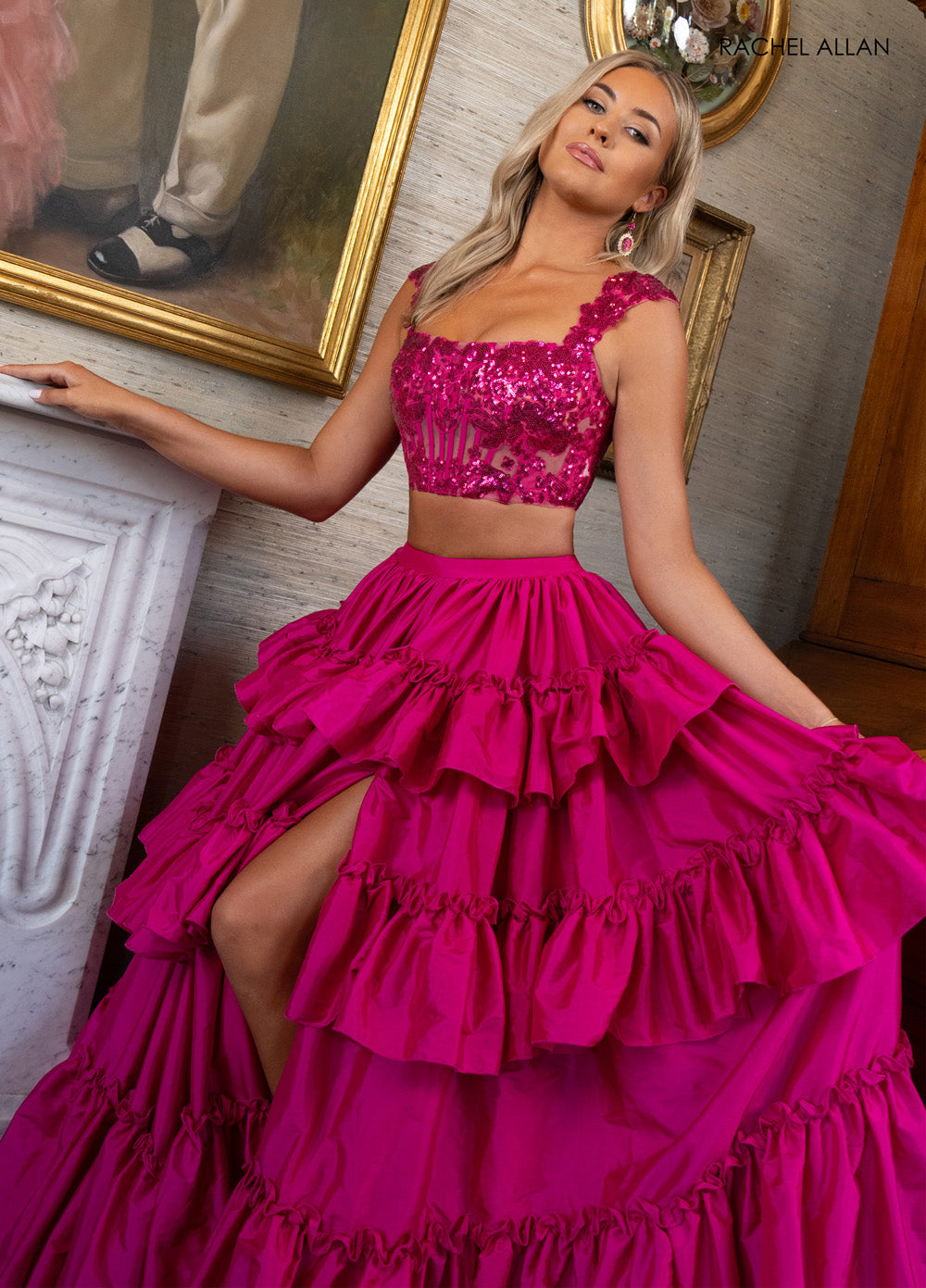 Rachel Allan 70966 Fuchsia prom dress with ruffled skirt and high slit, featuring sequin appliqué.