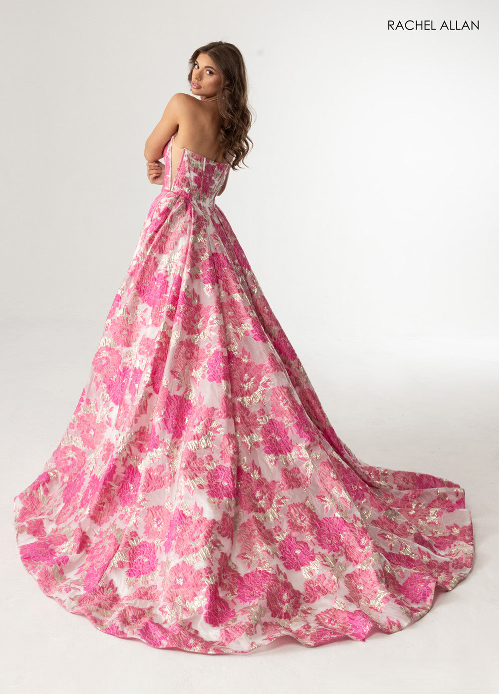 Rachel Allan 70975 Pink multi formal gown with floral jacquard and a dramatic train, back view.