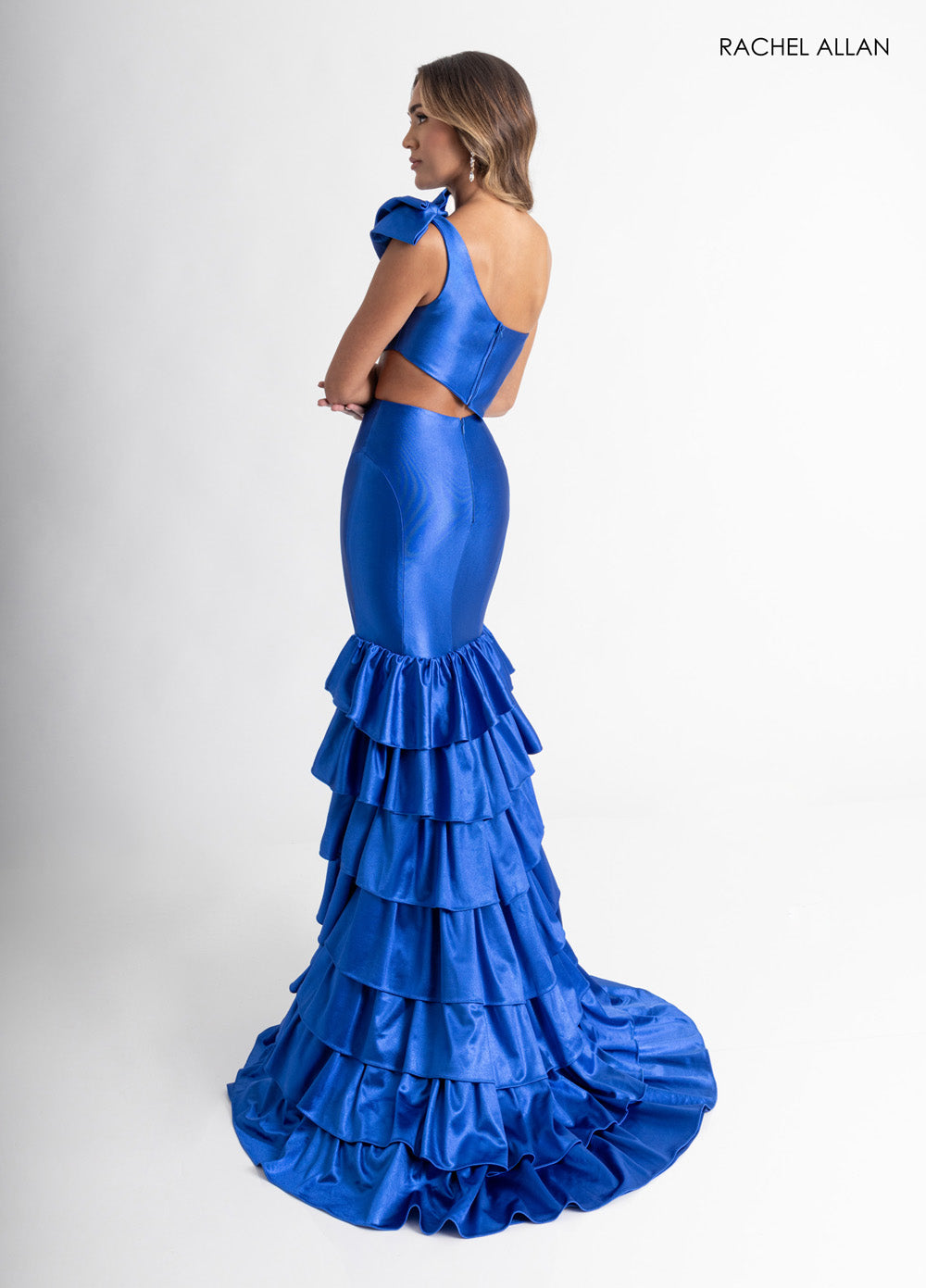 Rachel Allan 70976 Royal blue mermaid prom dress with ruffled skirt and open back detail.