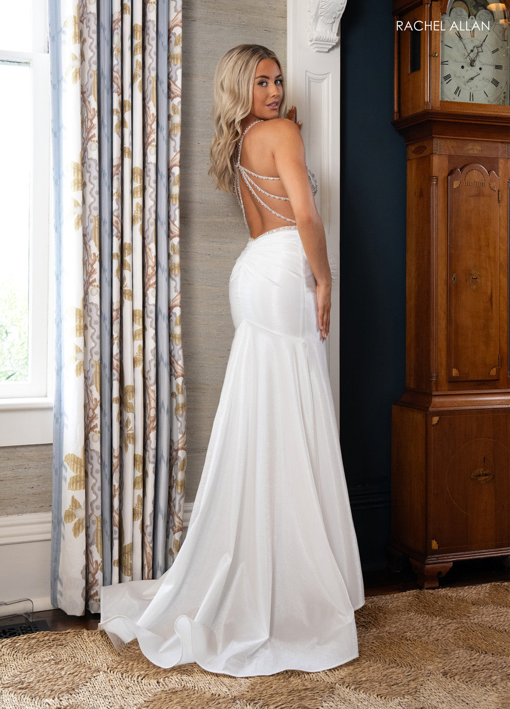 Rachel Allan 70983 White mermaid prom dress with lace-up low back and crystal beading details.