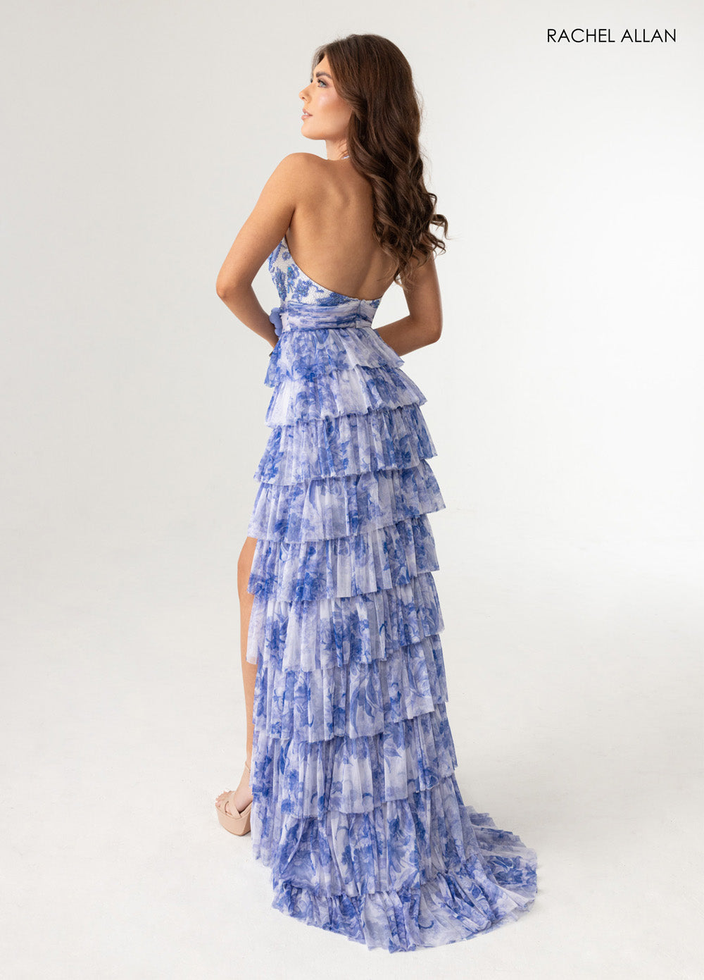 Rachel Allan 70985 Blue tiered prom dress with a lace-up back and high slit, back view.