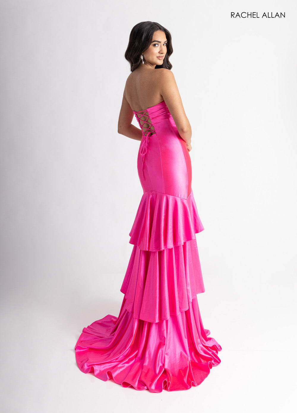 Rachel Allan 70987 Fitted hot pink prom dress with a lace-up back and layered ruffle train.