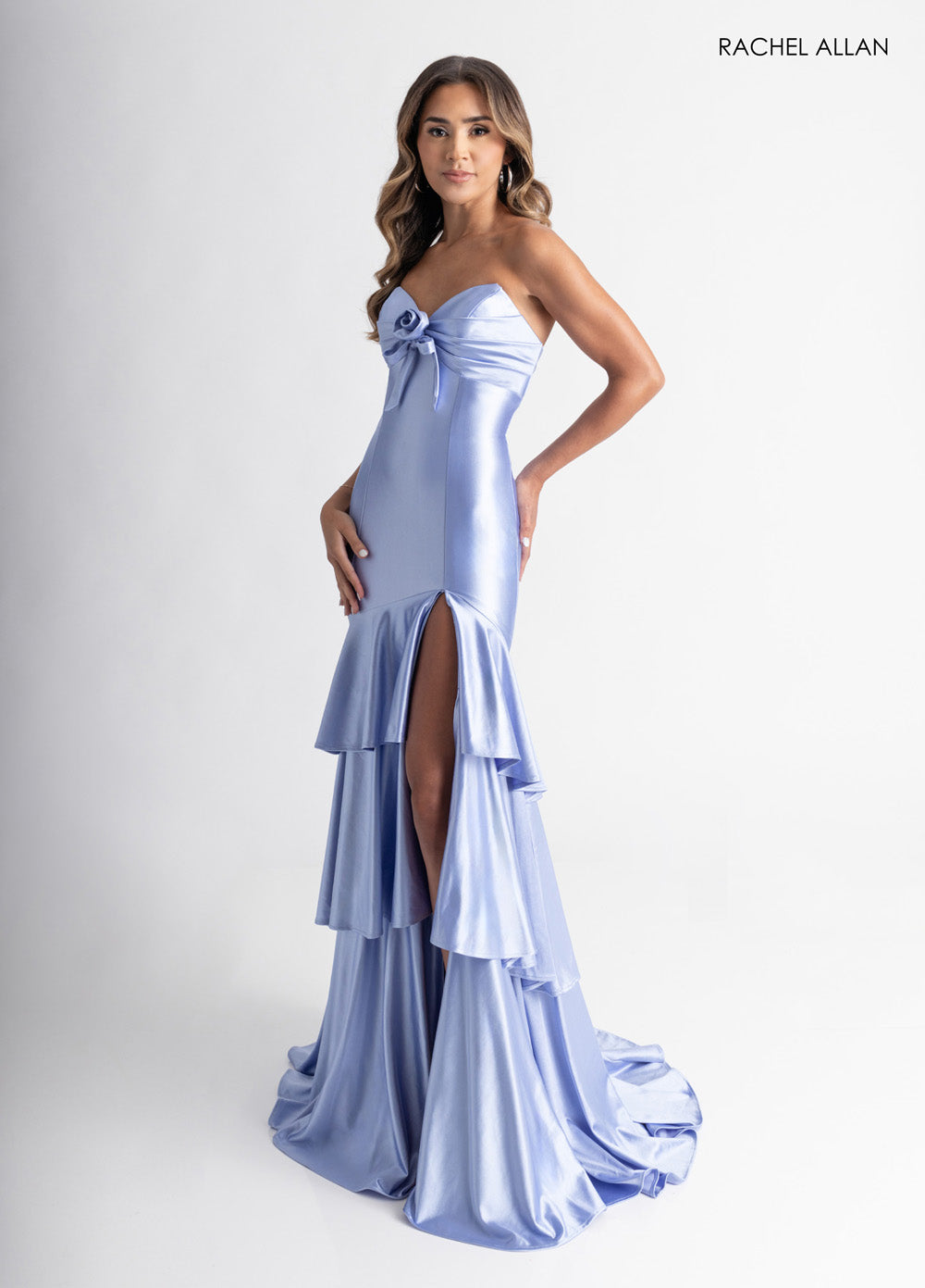 Rachel Allan 70987 Cloud blue mermaid prom dress with a high slit and layered ruffle hem.