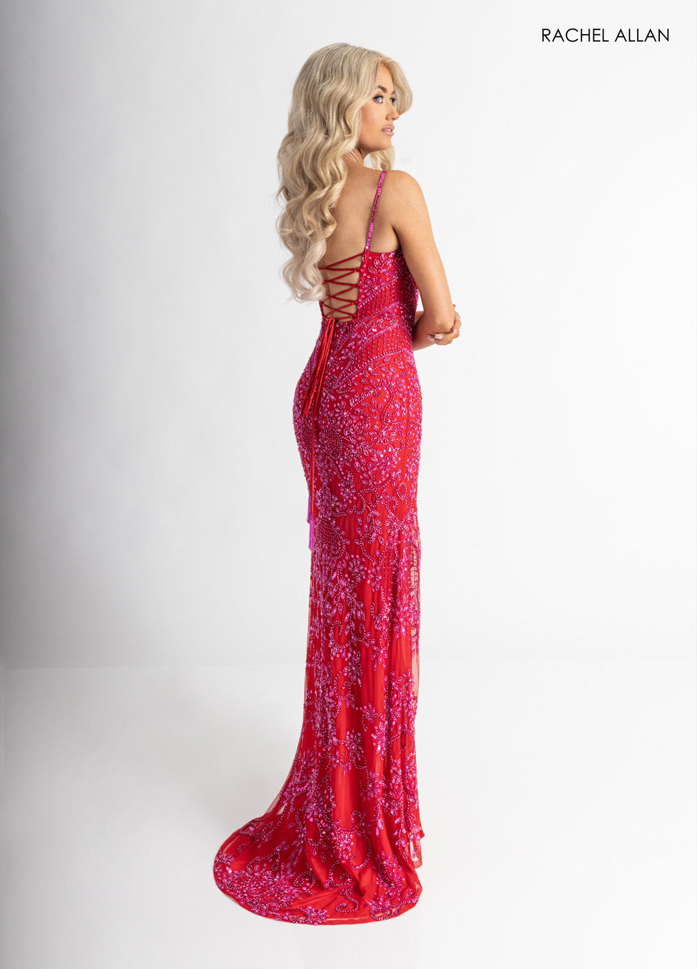 Rachel Allan 70999 Red formal gown with a lace-up back and elegant beading, side view.