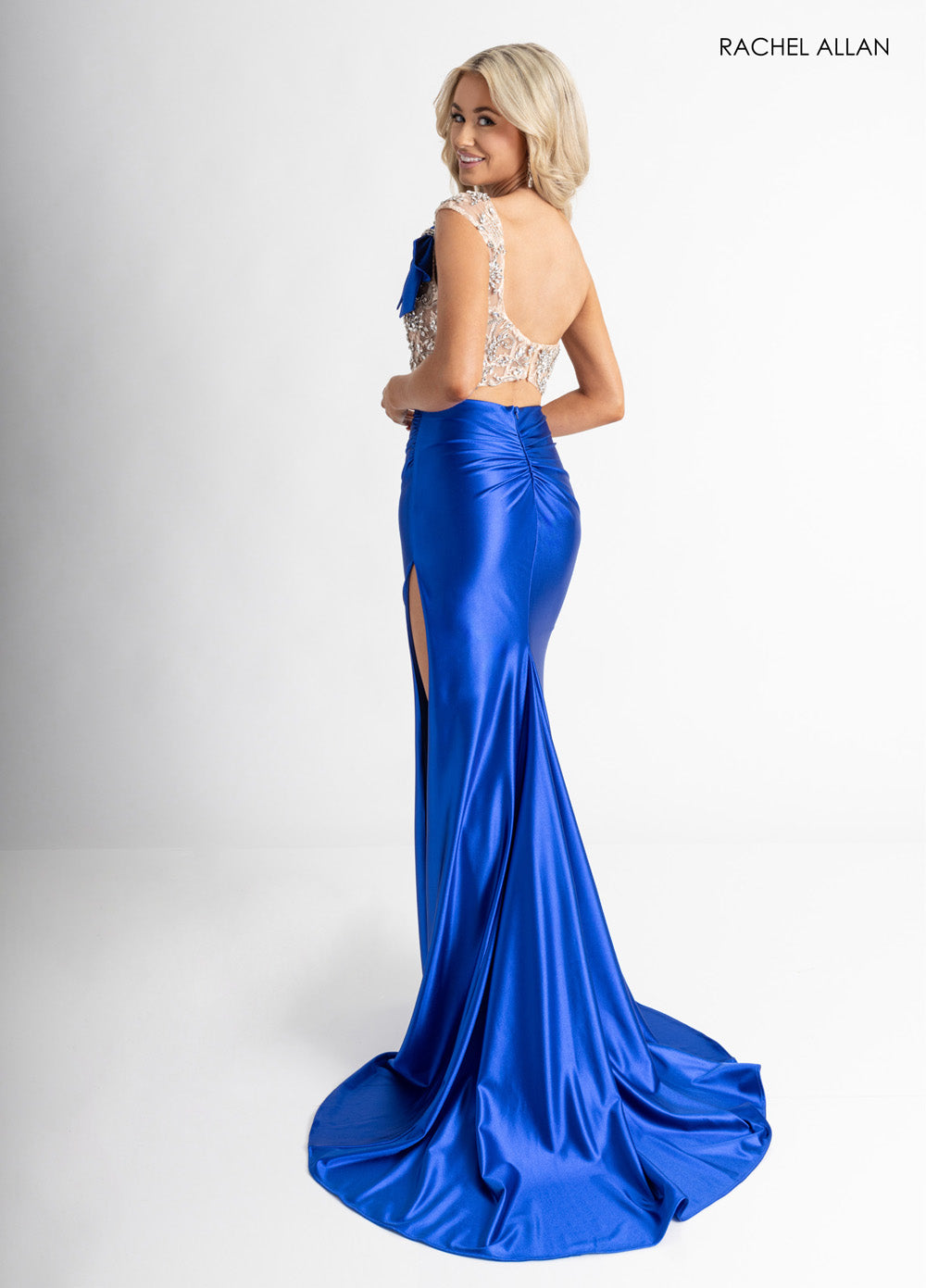 Rachel Allan 71000 Royal blue mermaid prom dress with crystal beading and a high slit, back view.