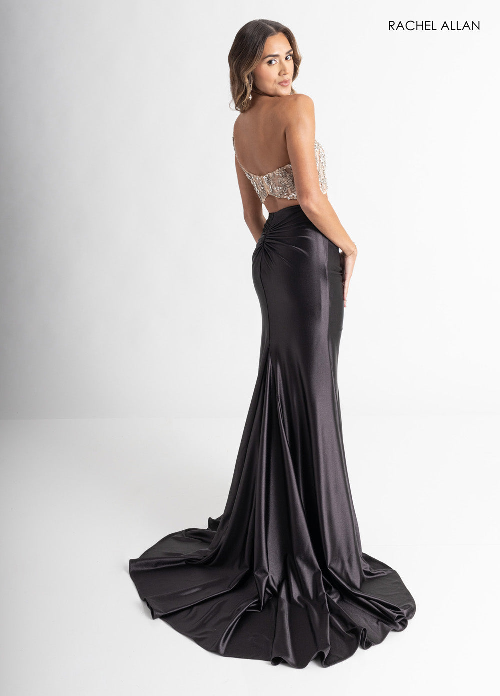 Rachel Allan 71000 Black mermaid prom dress with crystal beading and a dramatic train, back view.