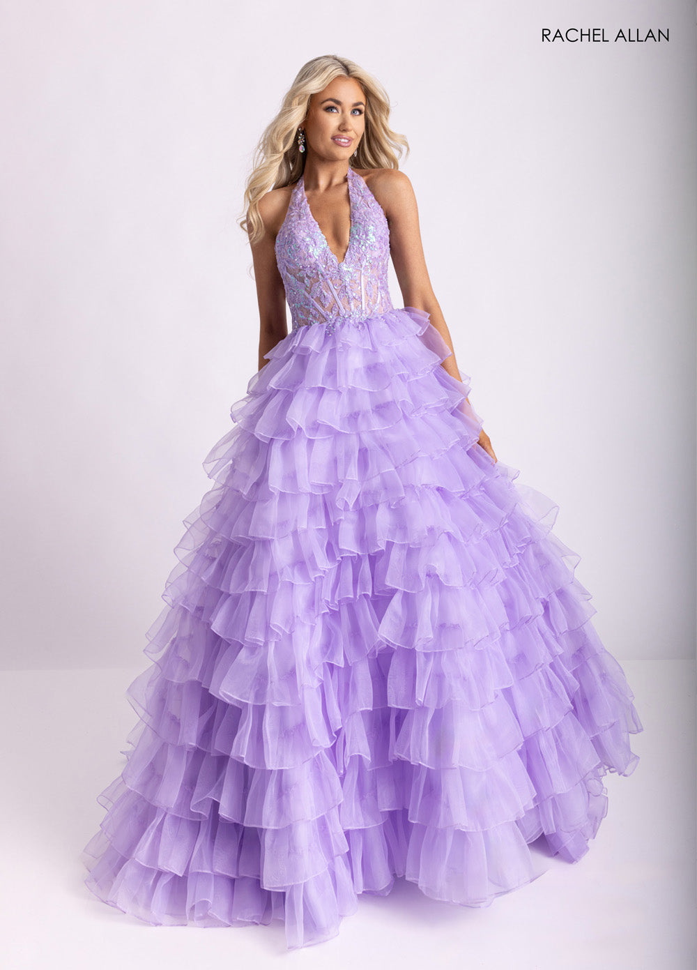 Rachel Allan 71006 Lilac prom dress with a ruffled ballgown silhouette and beaded corset bodice.