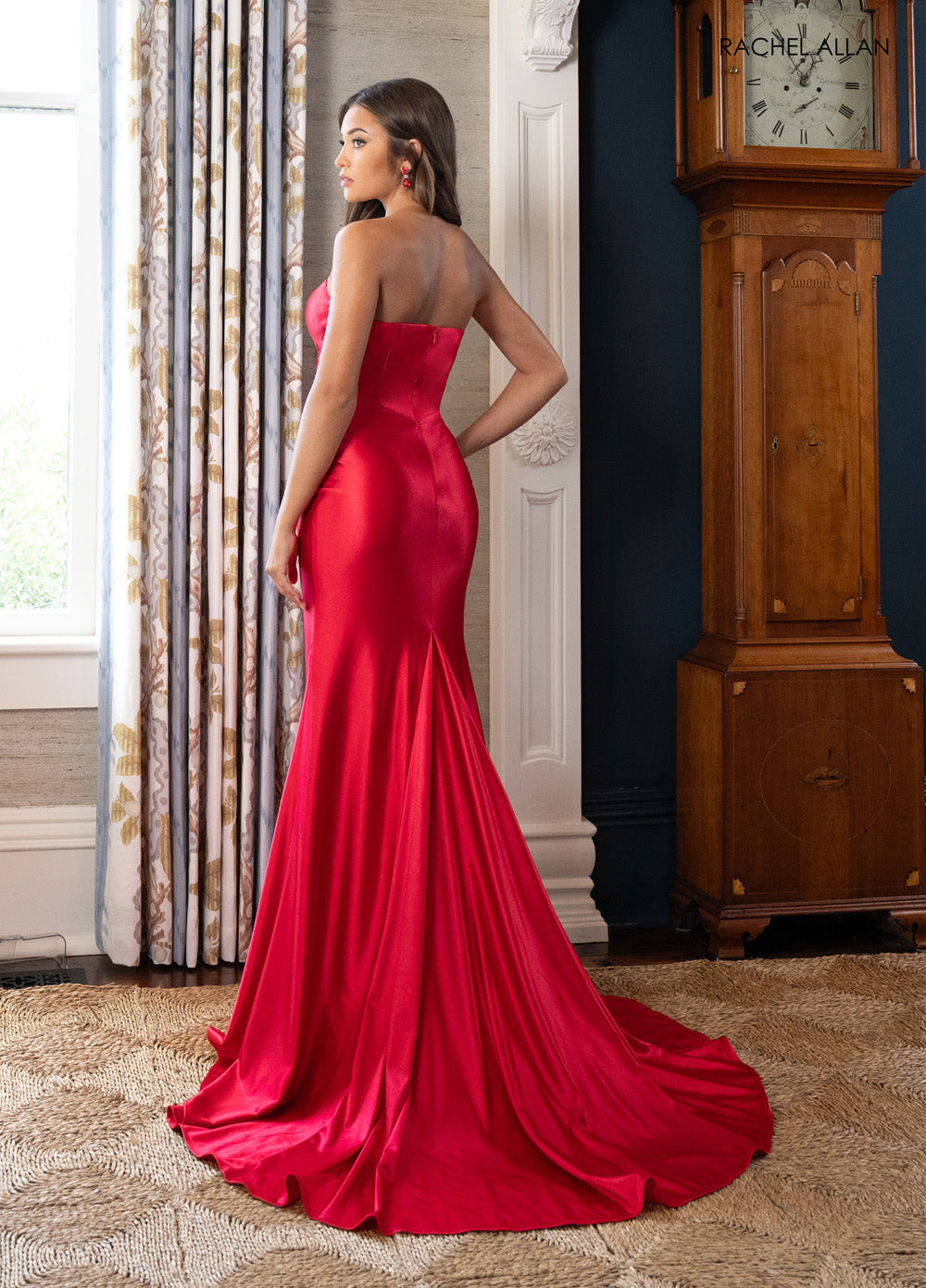 Rachel Allan 71022 Red mermaid prom dress with crystal beading and a dramatic train, back view.