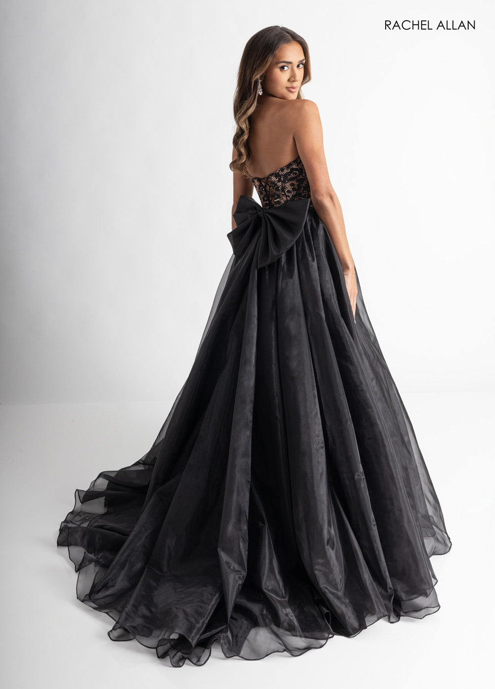Rachel Allan 71026 Black cheetah prom dress with a fitted bodice and dramatic bow detail at the back.