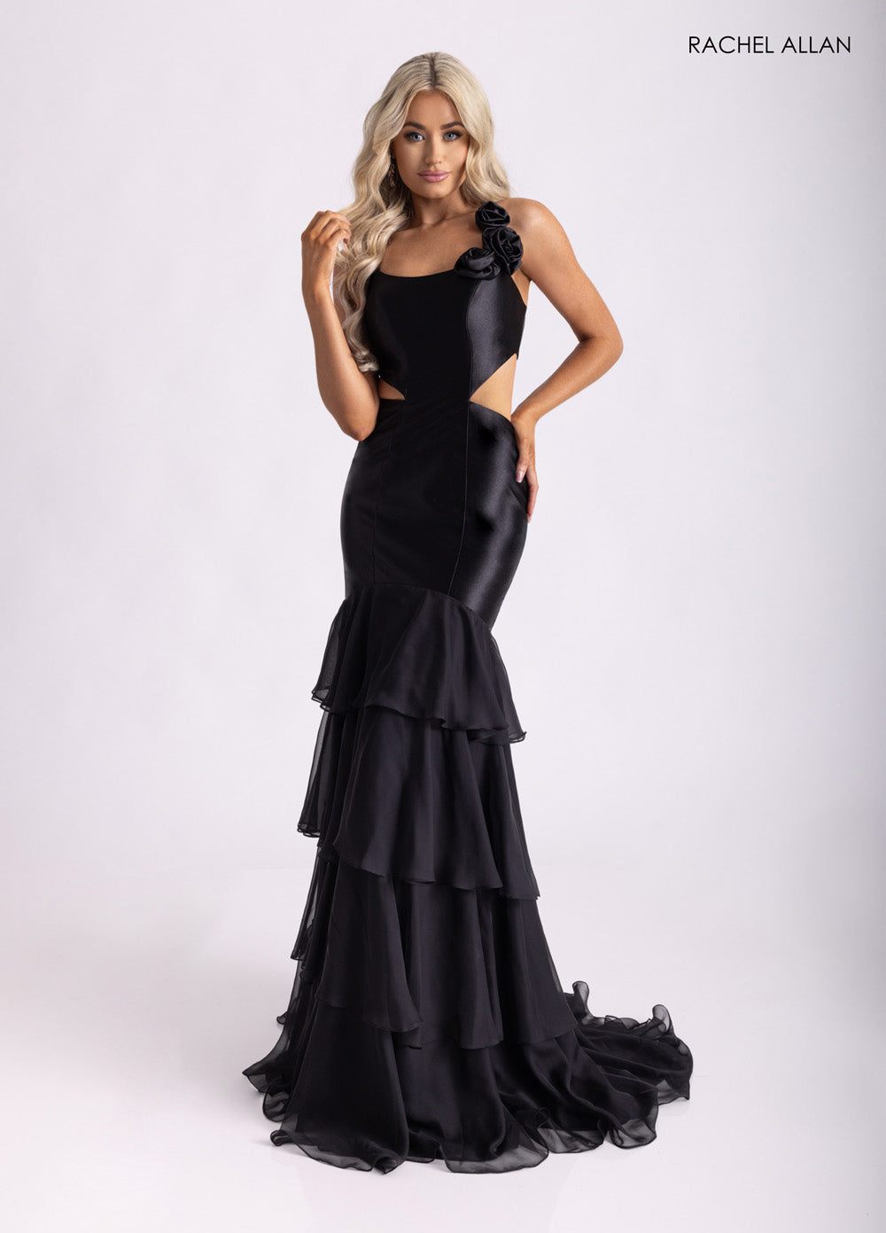 Rachel Allan 71027 Black mermaid prom dress with ruffled layers and 3D flower detail.