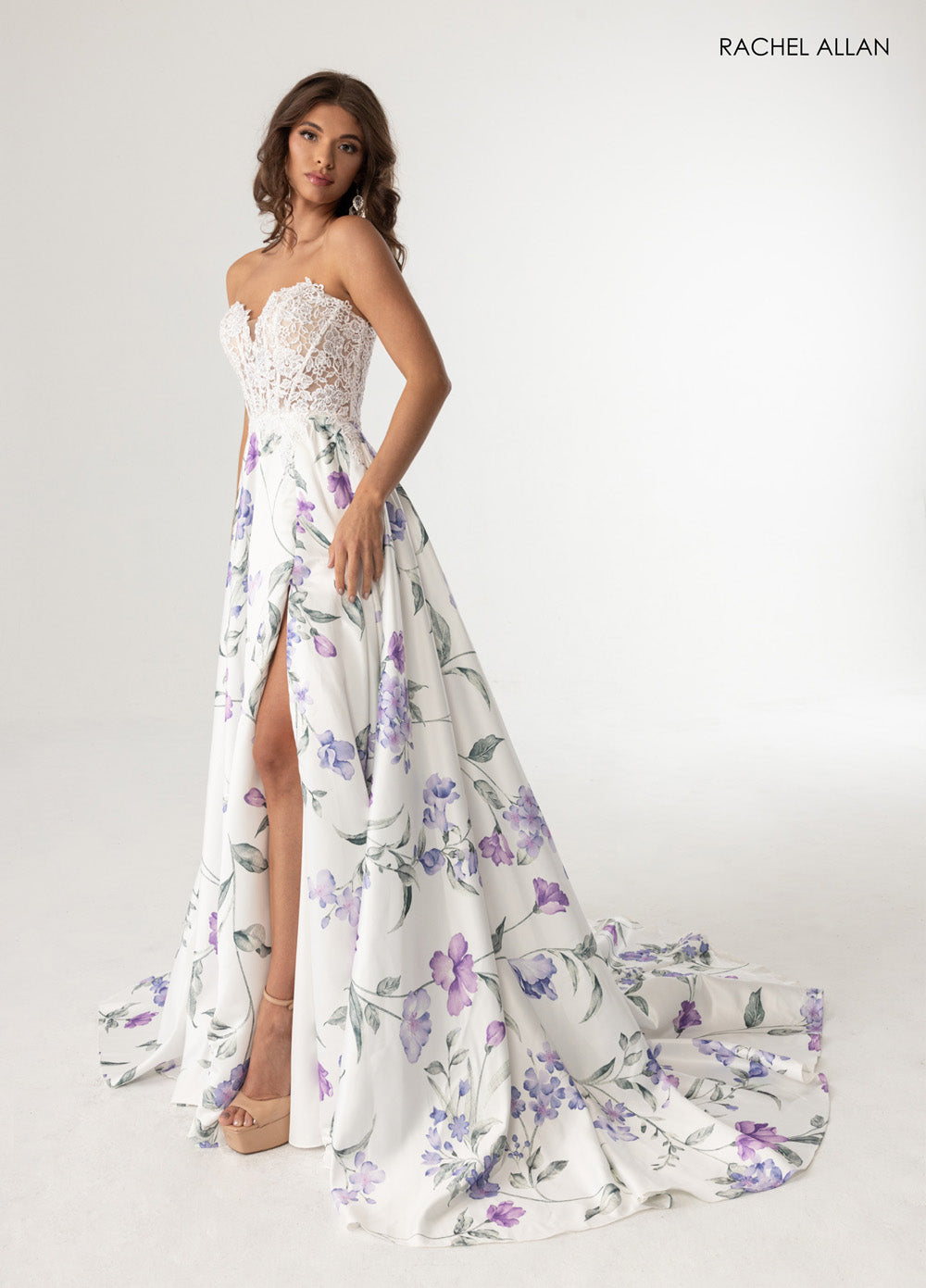 Rachel Allan 71031 White floral prom dress with a high slit and intricate lace bodice, front view.