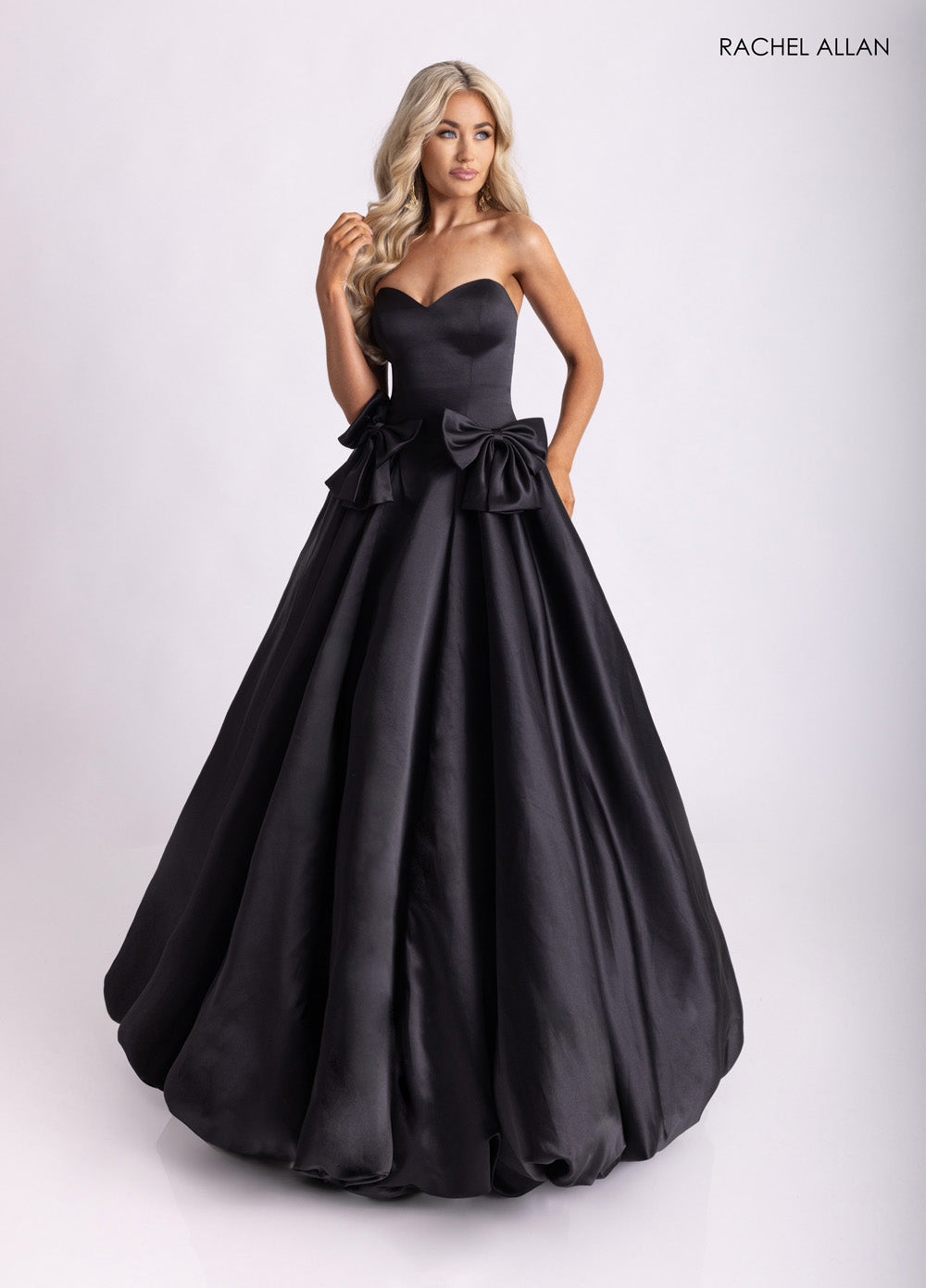 Rachel Allan 71035 Black ballgown prom dress with a sweetheart neckline and oversized bows.