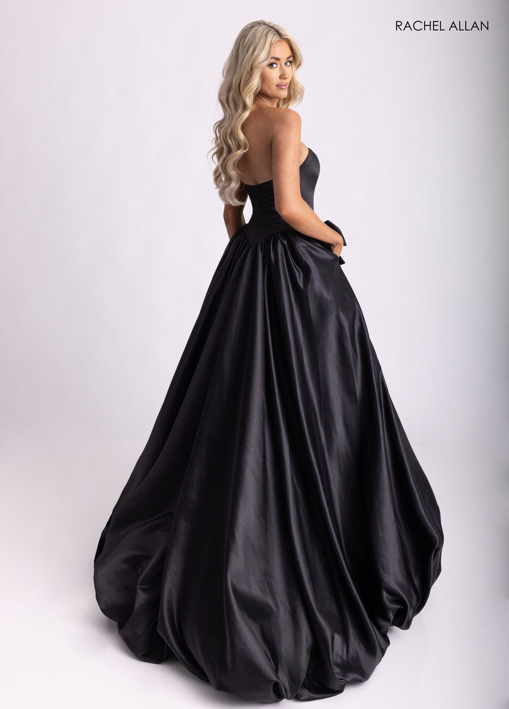 Rachel Allan 71035 Black ballgown prom dress with a dramatic skirt and lace-up back detail.