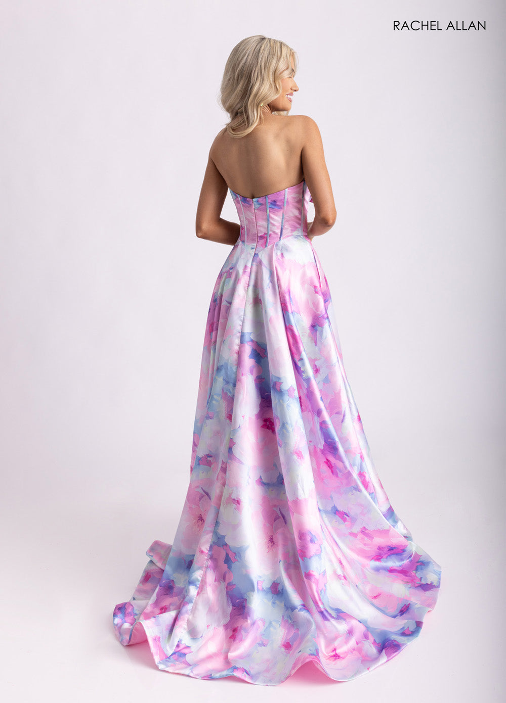 Rachel Allan 71036 Strapless pink multi prom dress with a flowing A-line silhouette and lace-up back.