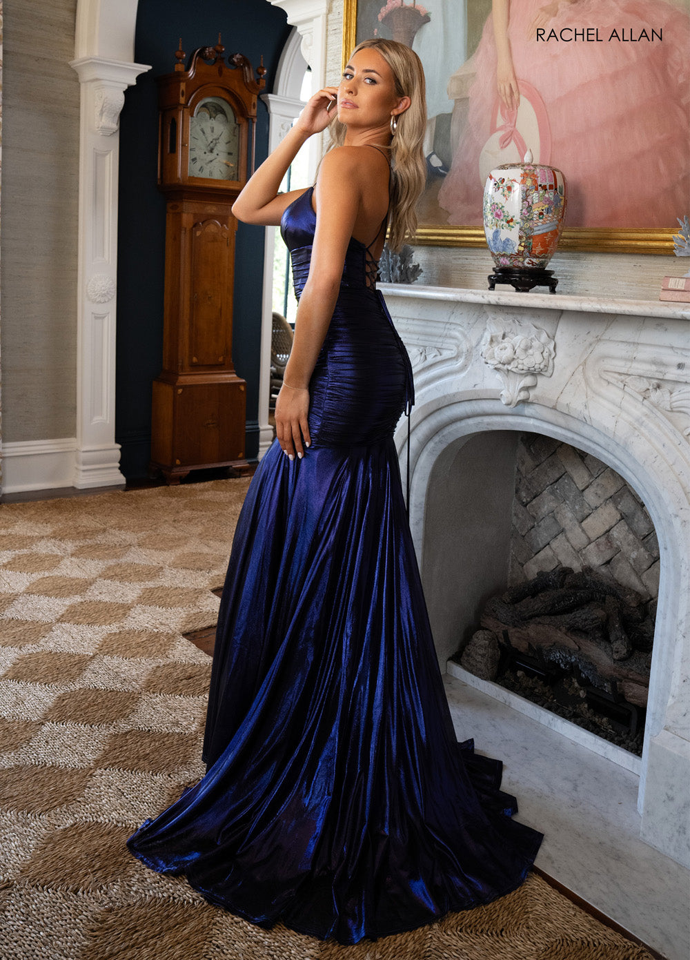 Rachel Allan 71040 Cobalt mermaid prom dress with a lace-up back and flowing train, side view.