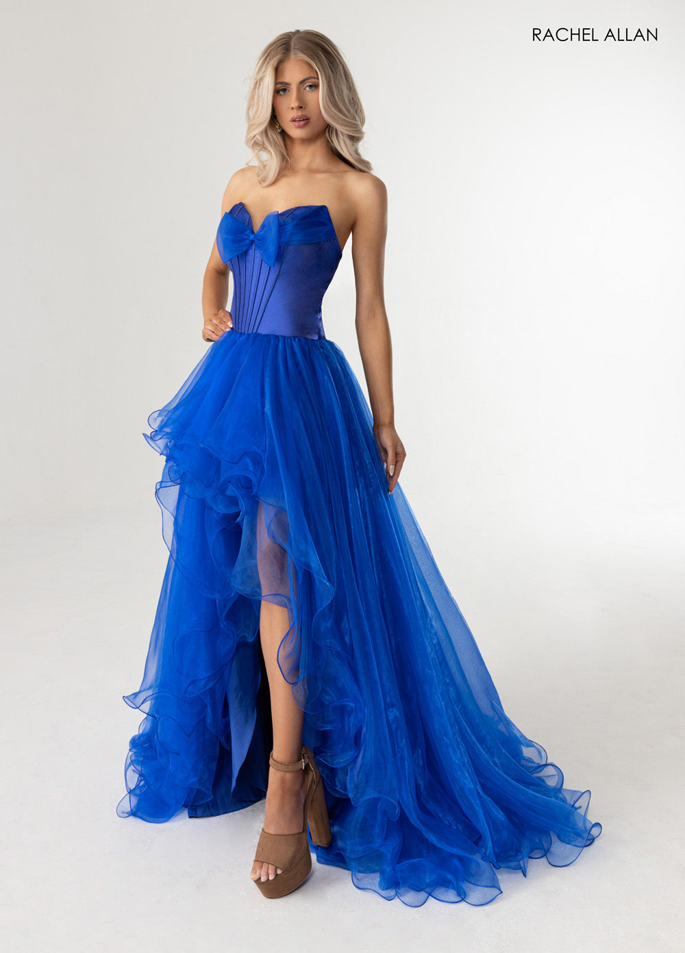 Rachel Allan 71046 Royal blue prom dress with a fitted bodice and ruffled high-low skirt.