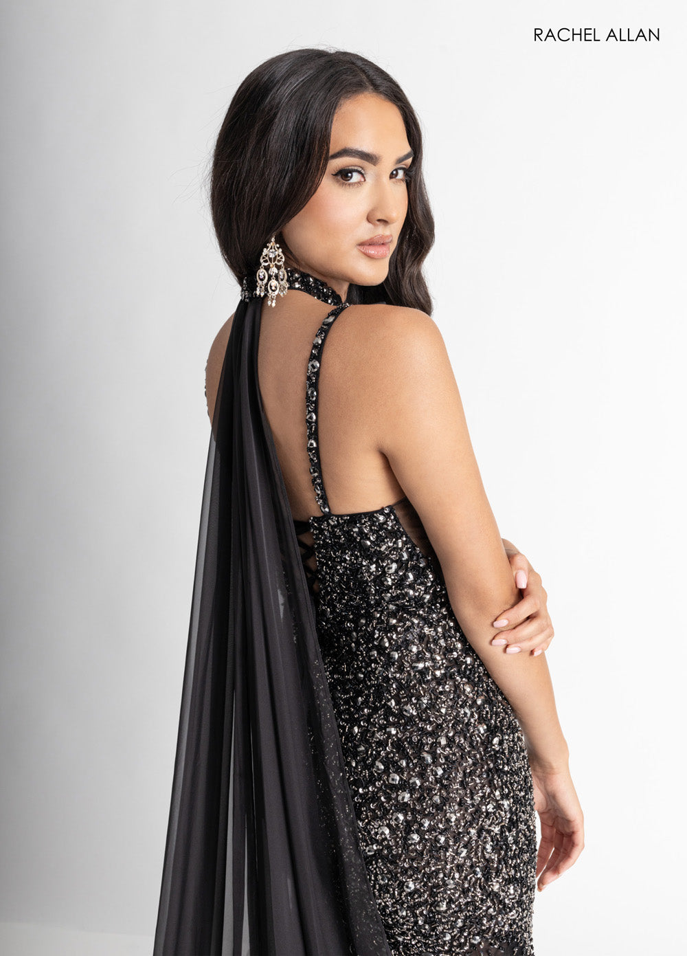 Rachel Allan 71047 Black fitted prom dress with crystal beading and a dramatic back cape.