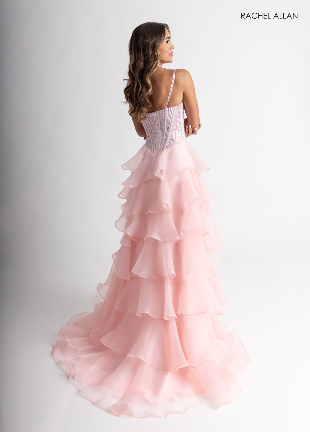 Rachel Allan 71049 Blush prom dress with layered ruffles and crystal beading, back view.