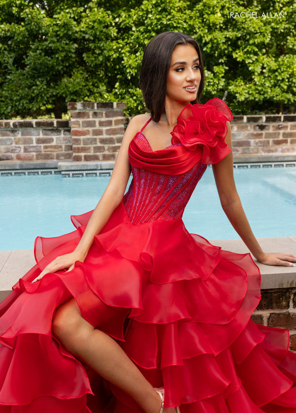 Rachel Allan 71049 Red prom dress with ruffled skirt and crystal beading, featuring a side view.