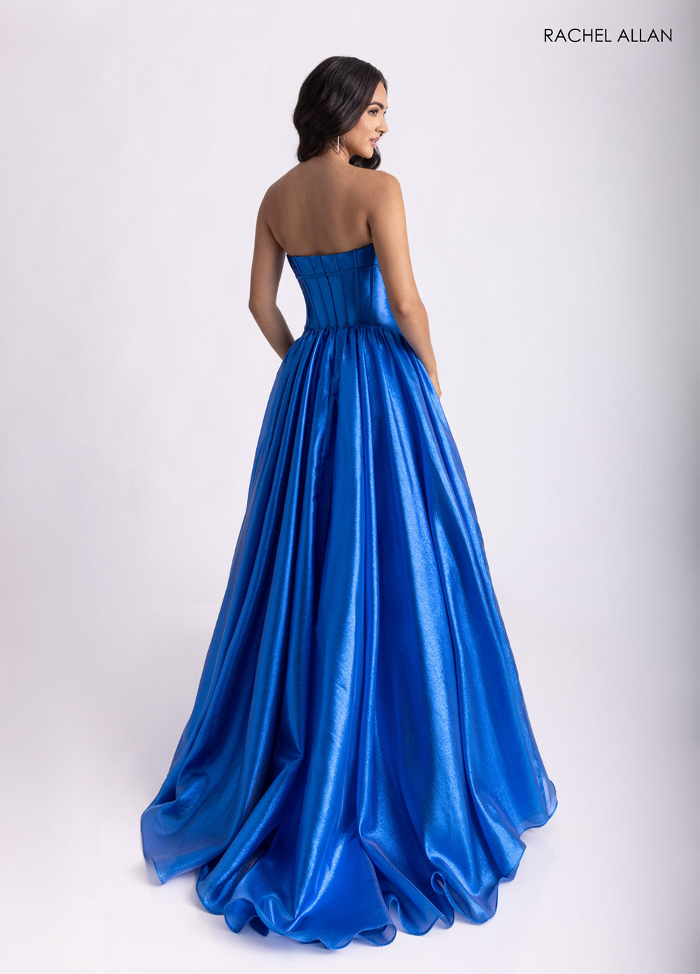 Rachel Allan 71060 Royal blue formal gown with a fitted bodice and flowing skirt, featuring a lace-up back.